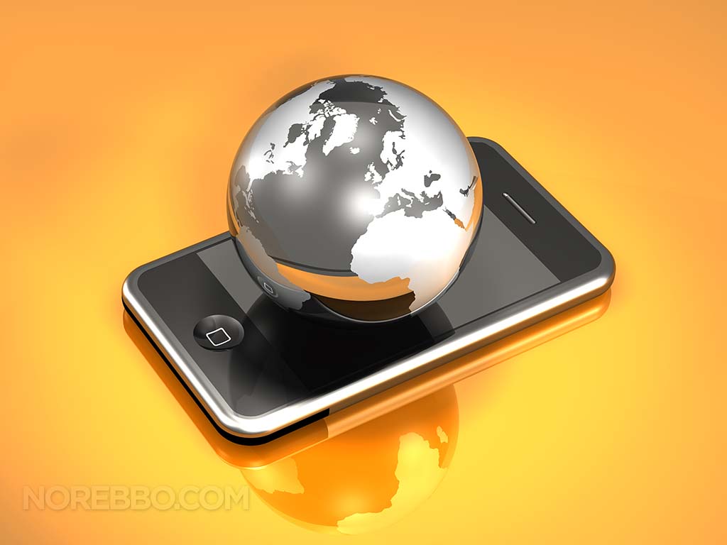A glossy silver and black globe sitting on top of an iPhone 3Gs